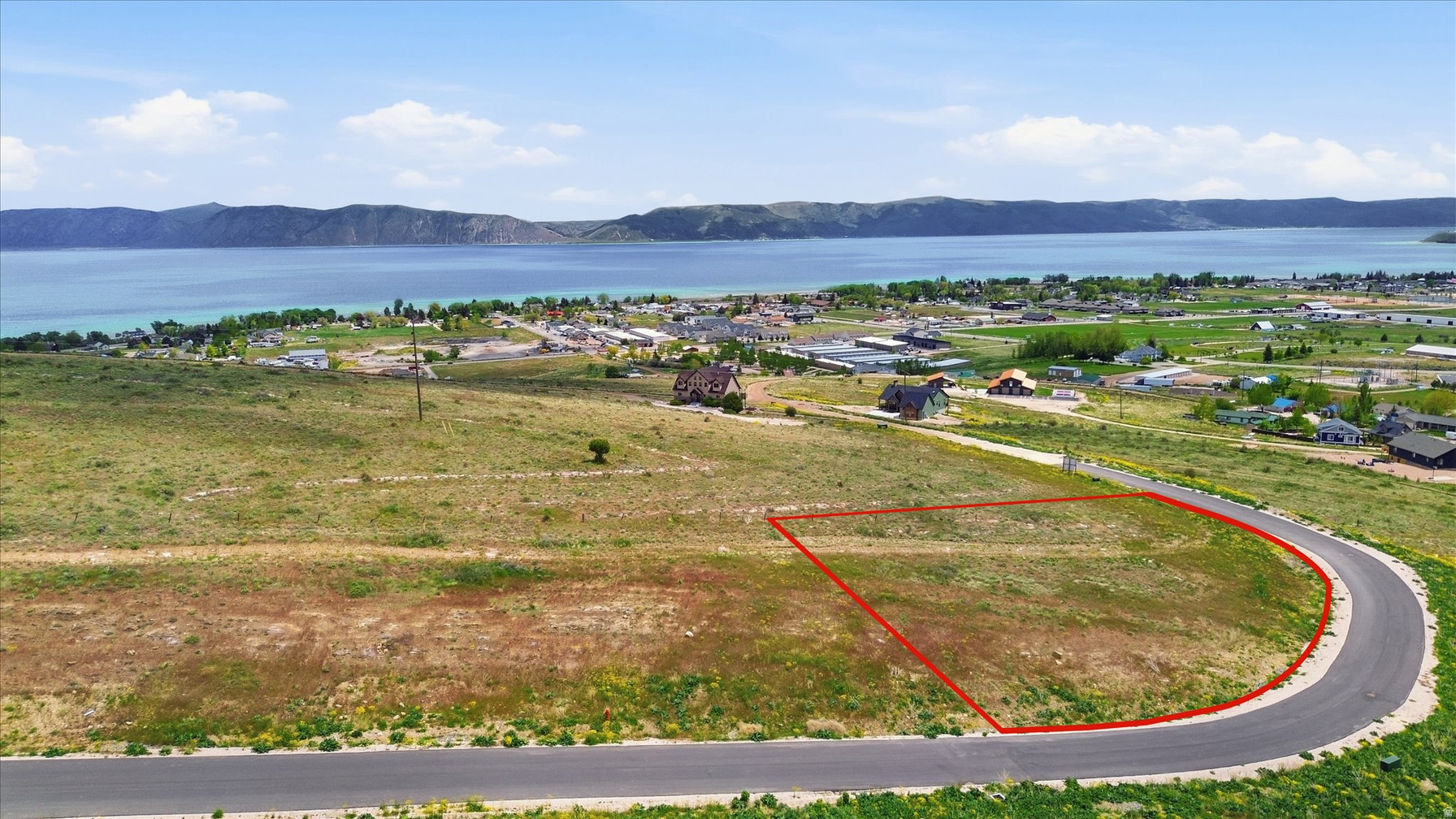 Lot 65 outlined in red on the Lakeview at Bear Lake hillside with the turquoise lake and mountains beyond